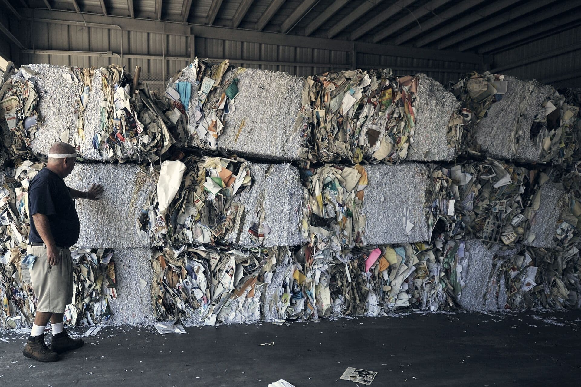 Compressed bales of mixed paper stacked in a warehouse