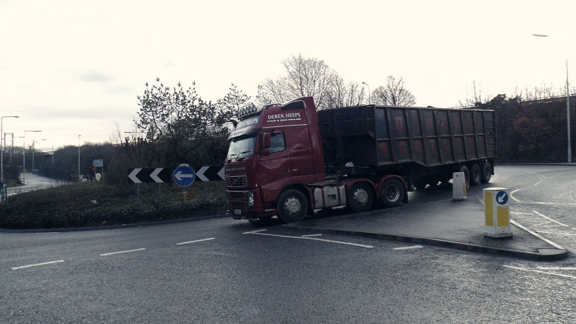 Loaded scrap truck leaving on the road